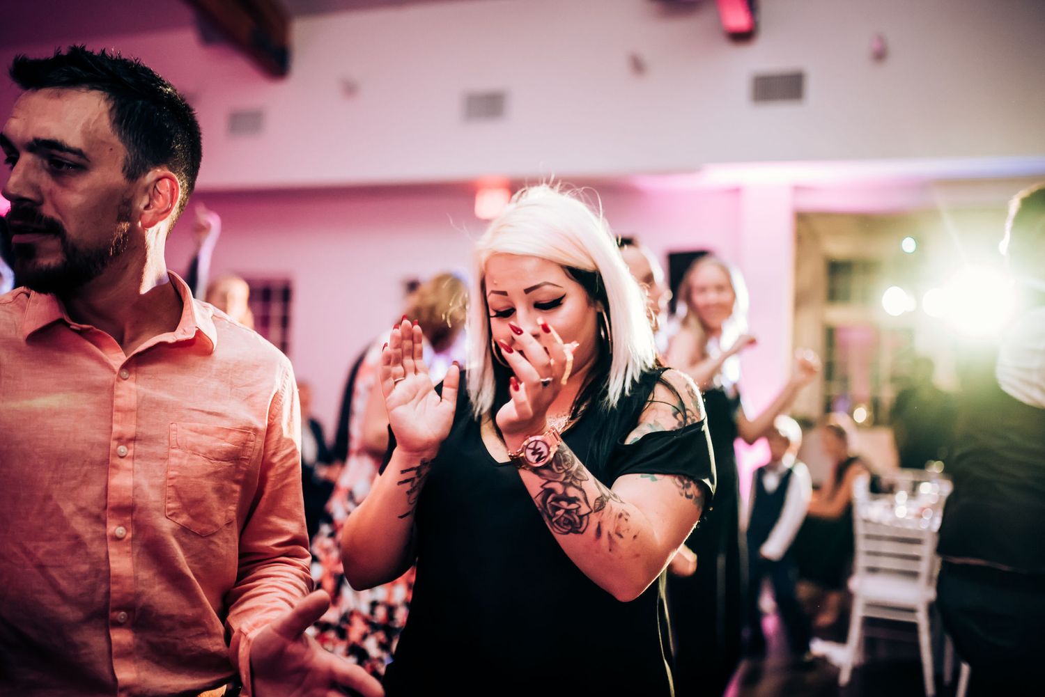 Party guests react emotionally during a special moment at an indoor celebration.
