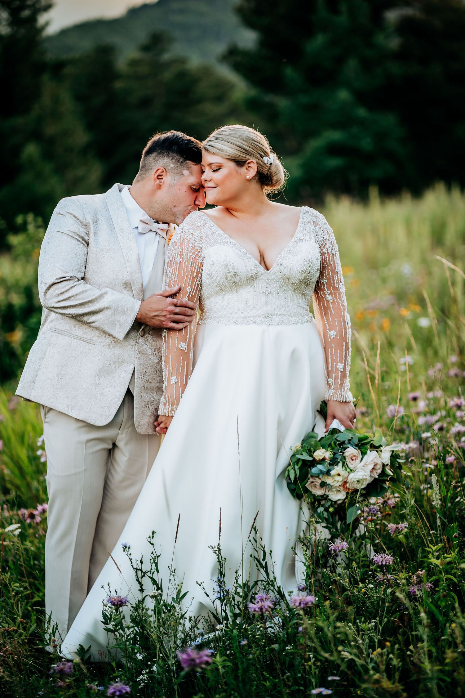 Romantic outdoor wedding portrait in a wildflower meadow.