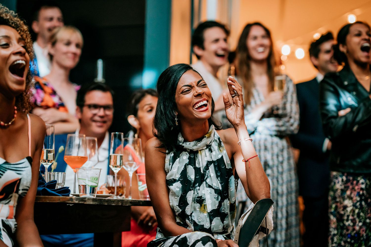 Audience members share joyful laughter during an entertainment show.