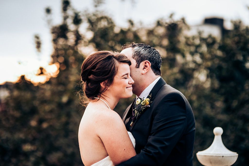 Intimate sunset wedding portrait with soft natural lighting.