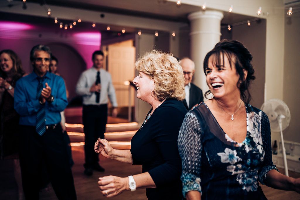 Guests dancing and laughing together at an elegant indoor celebration.