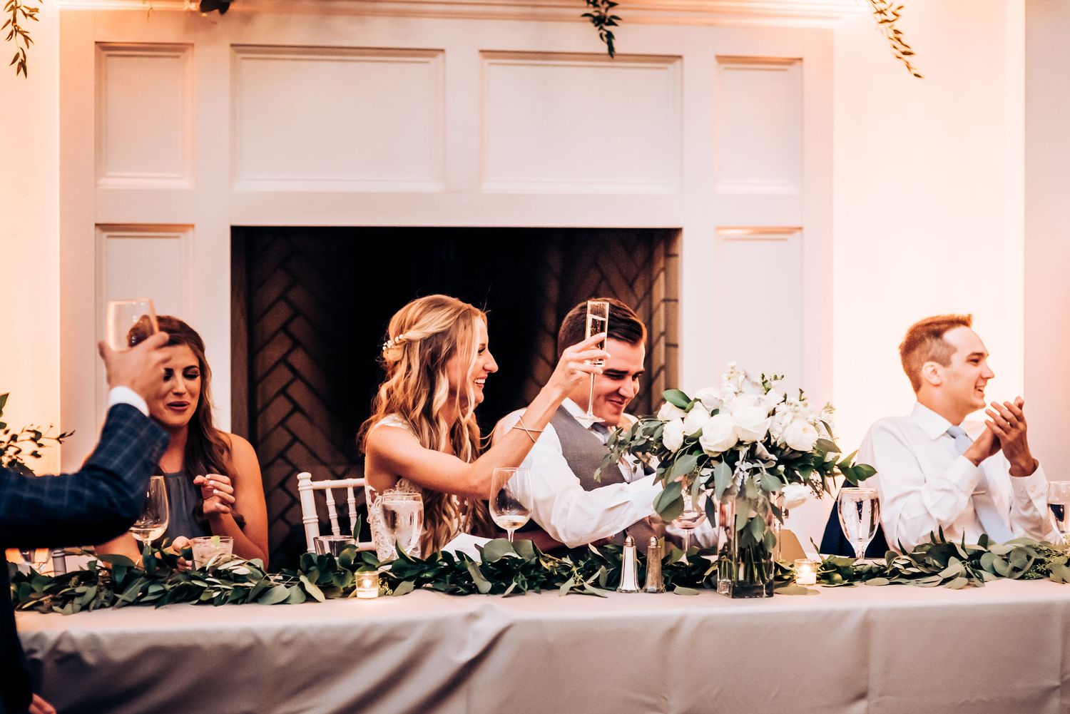 Reception head table scene with guests enjoying speeches and celebrations.