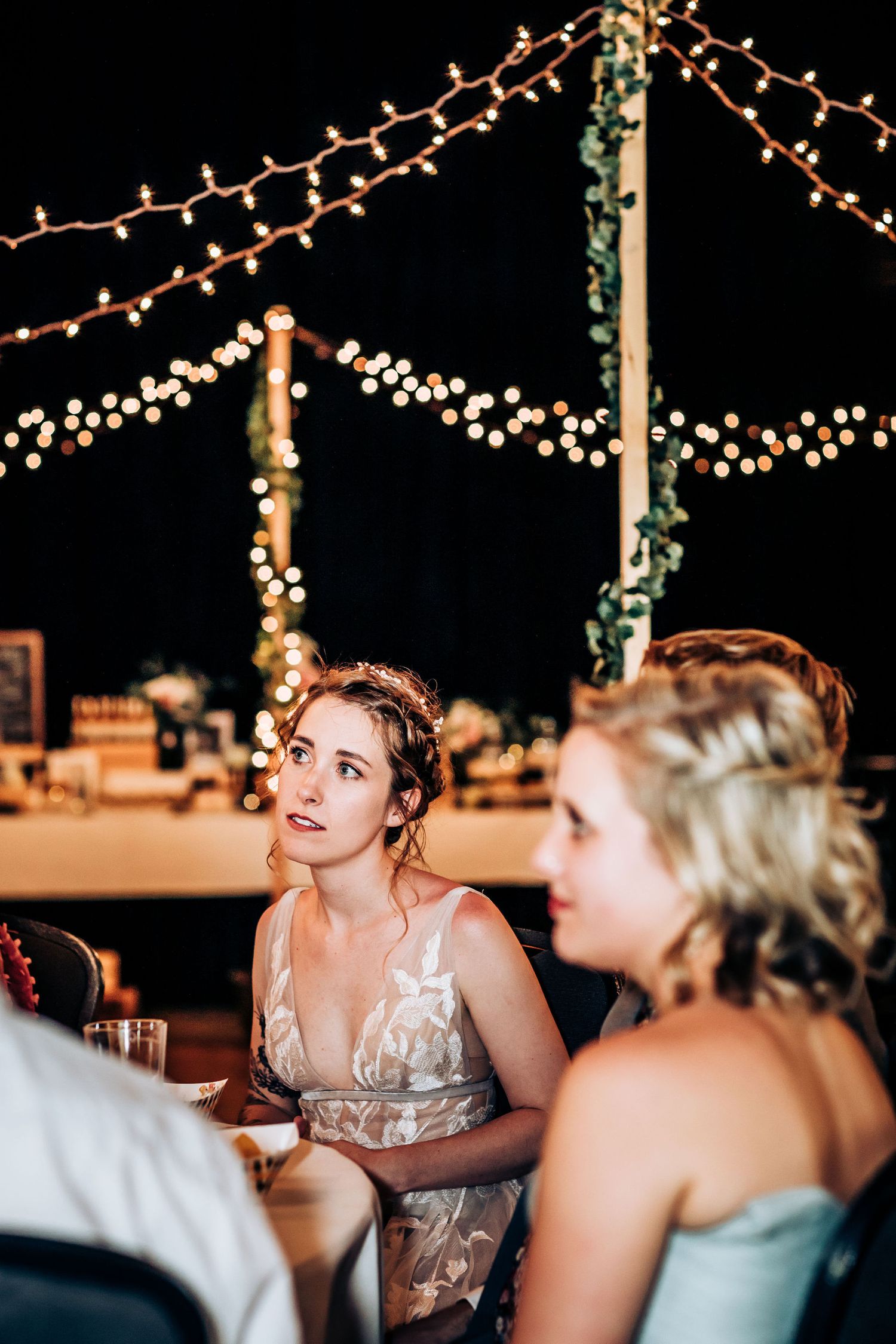 An elegant evening wedding reception under twinkling string lights.