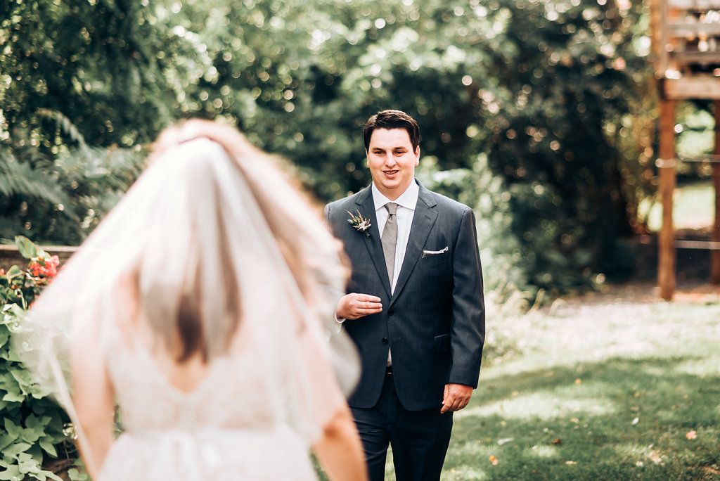 First look moment captured between couple during outdoor wedding ceremony.