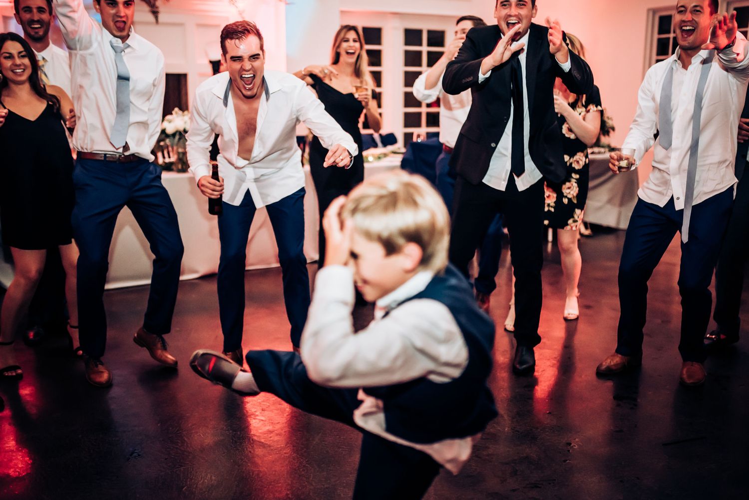 Fun dance floor moment at a wedding reception with guests showing off their moves.