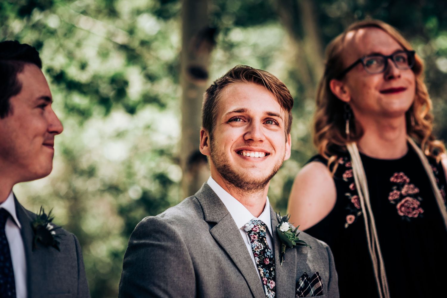 Candid reactions during outdoor forest wedding ceremony.