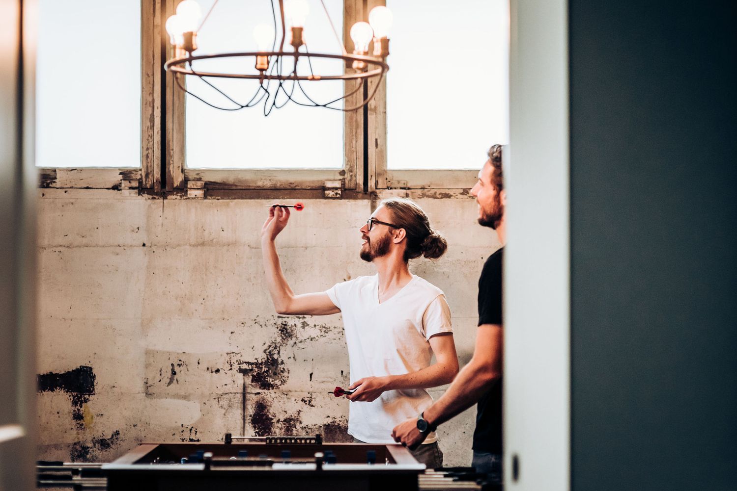 Behind the scenes at a styling session in an industrial space with natural light.