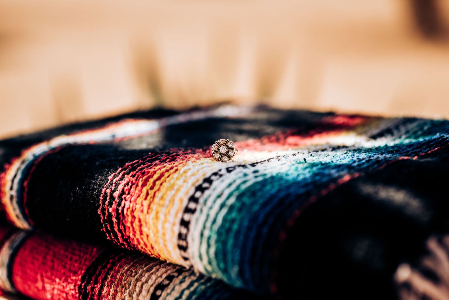 Macro detail of a colorful striped Mexican blanket texture.