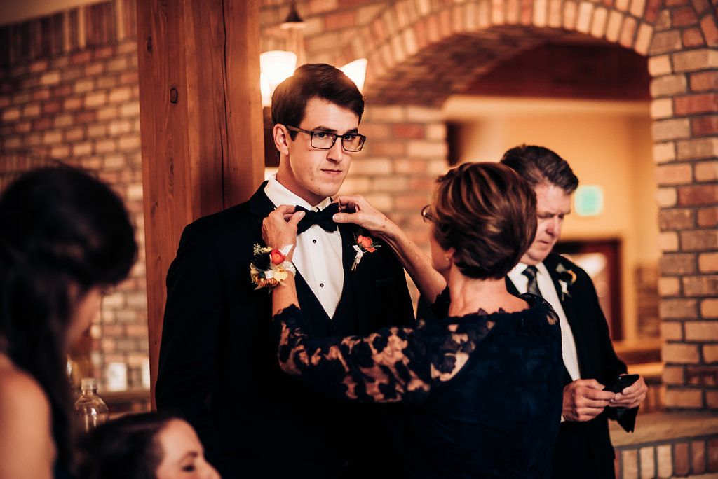 Wedding guests conversing at a rustic brick venue during the reception.