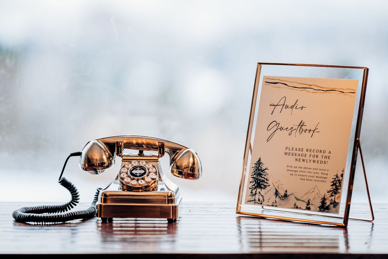 Vintage copper telephone next to framed wedding details card.
