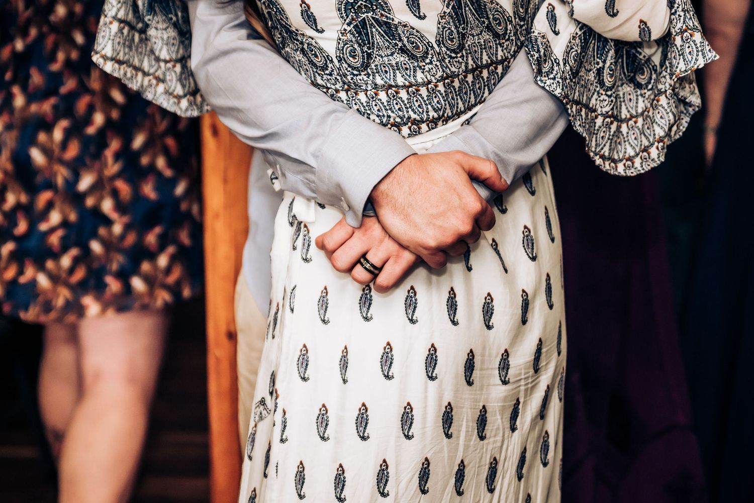 Close-up detail of a patterned white and black dress at a formal event.