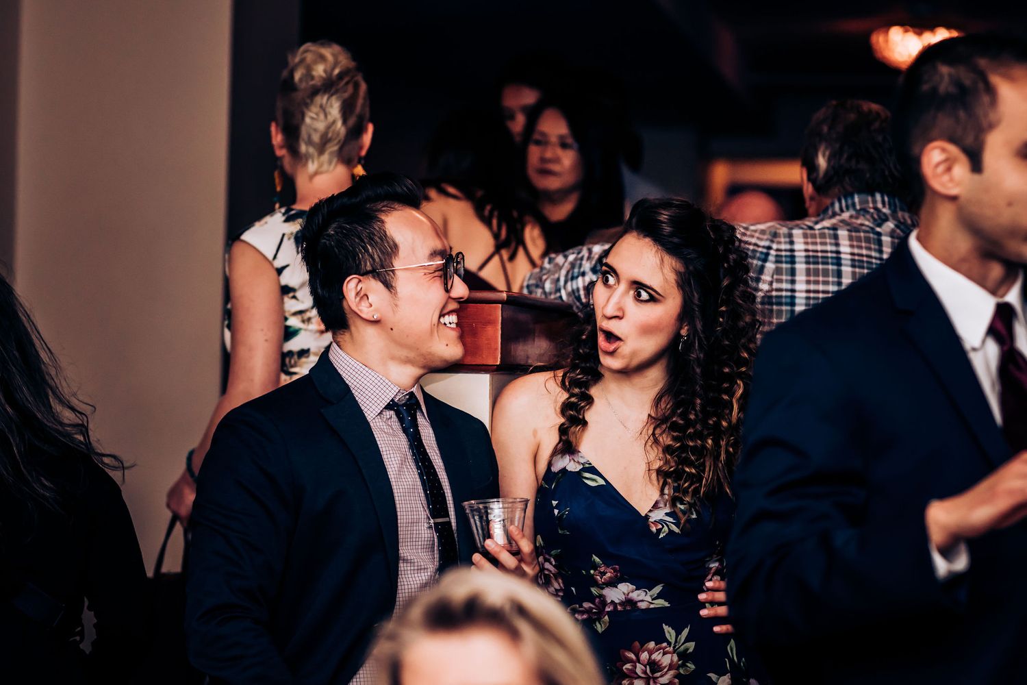 Wedding guests enjoying themselves on the dance floor at a reception.