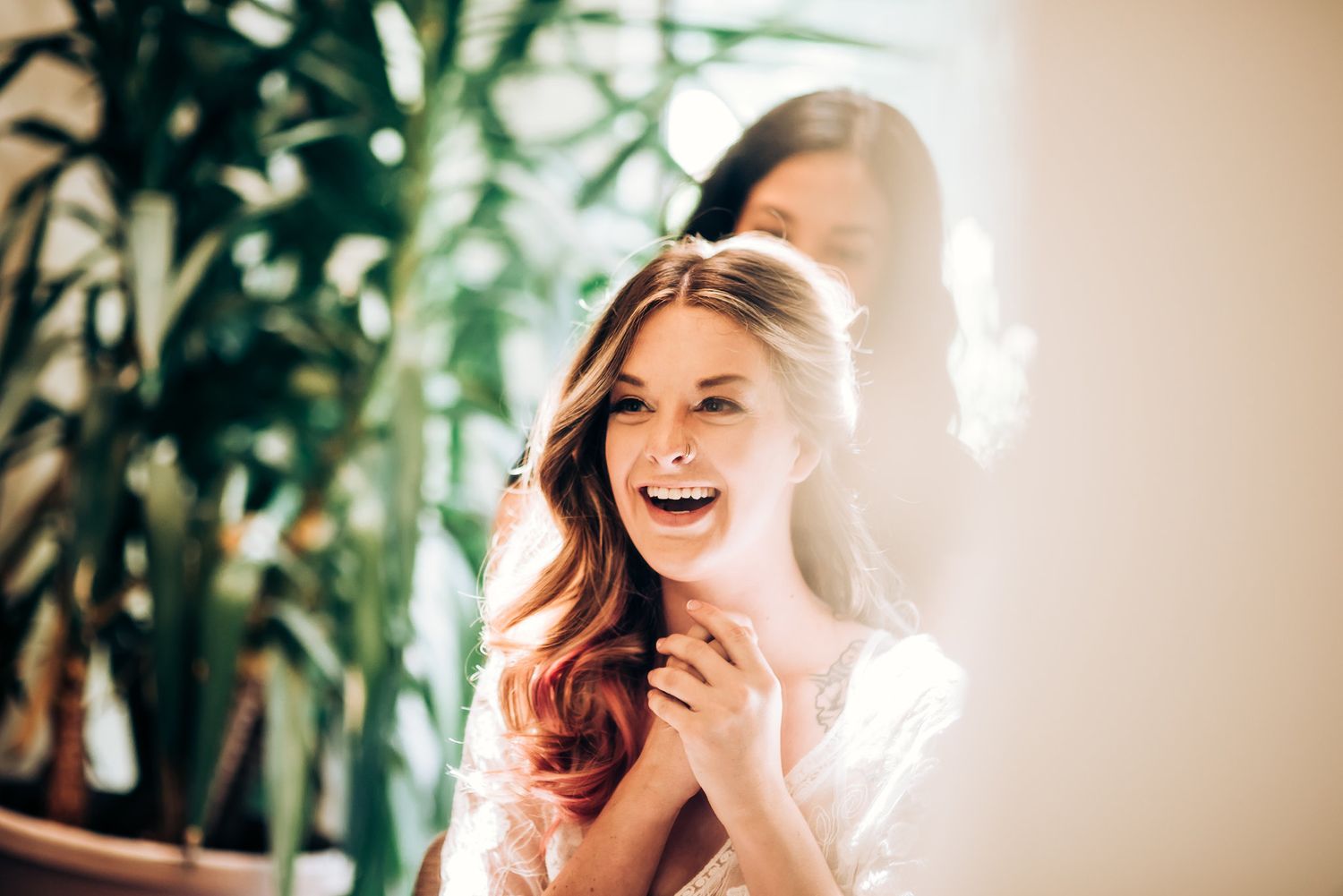 Bright sunlit portrait with natural window light and indoor plants.