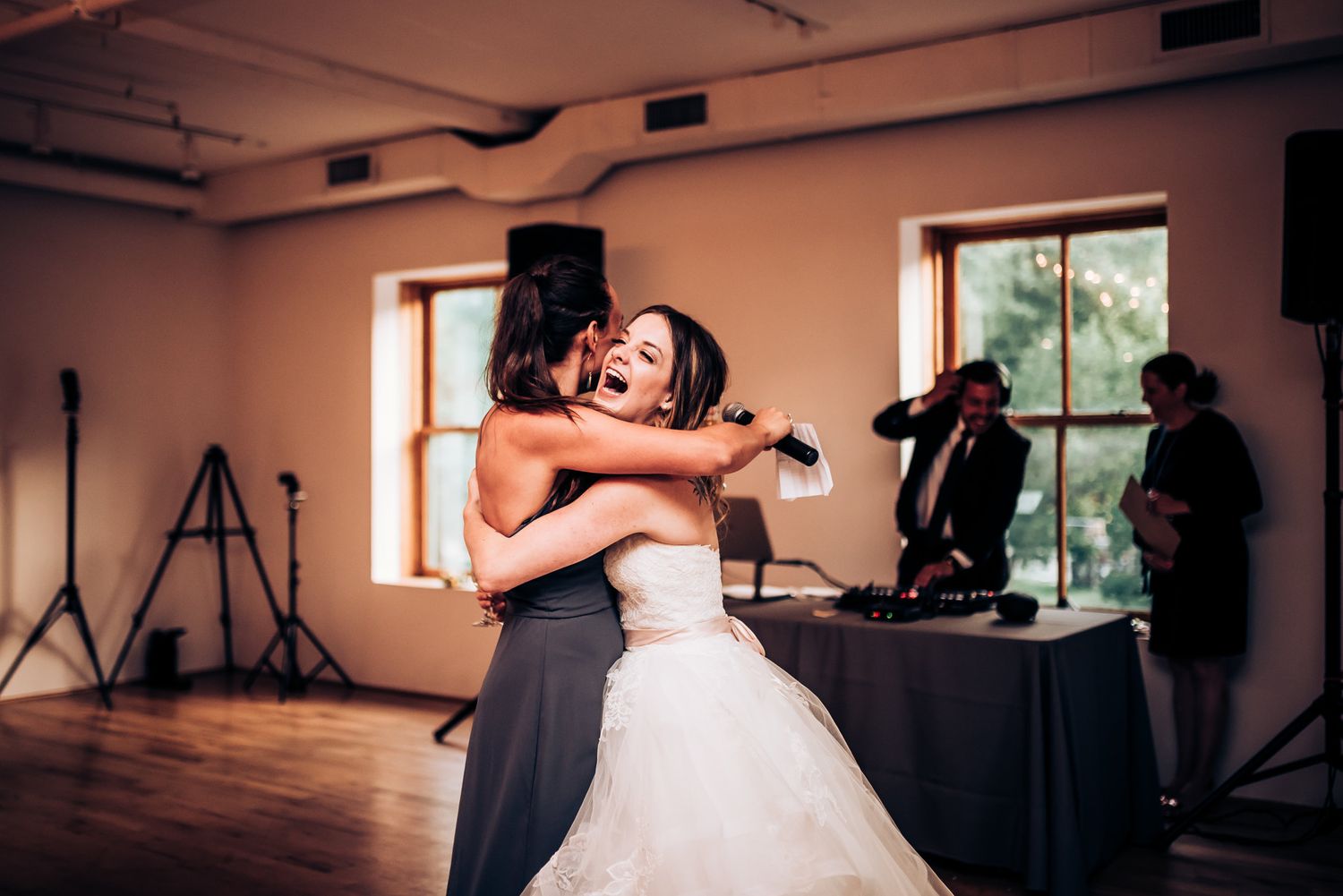Emotional embrace shared during a dance in a sunlit reception room.