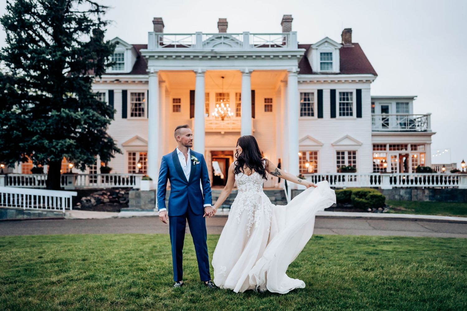 Elegant white colonial mansion wedding venue with columns and landscaped grounds.