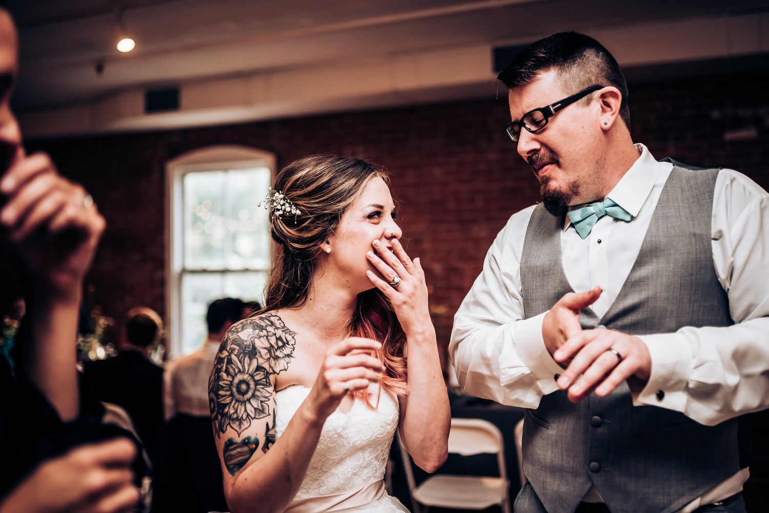 Candid reception moment showing laughter and joy during the celebration.