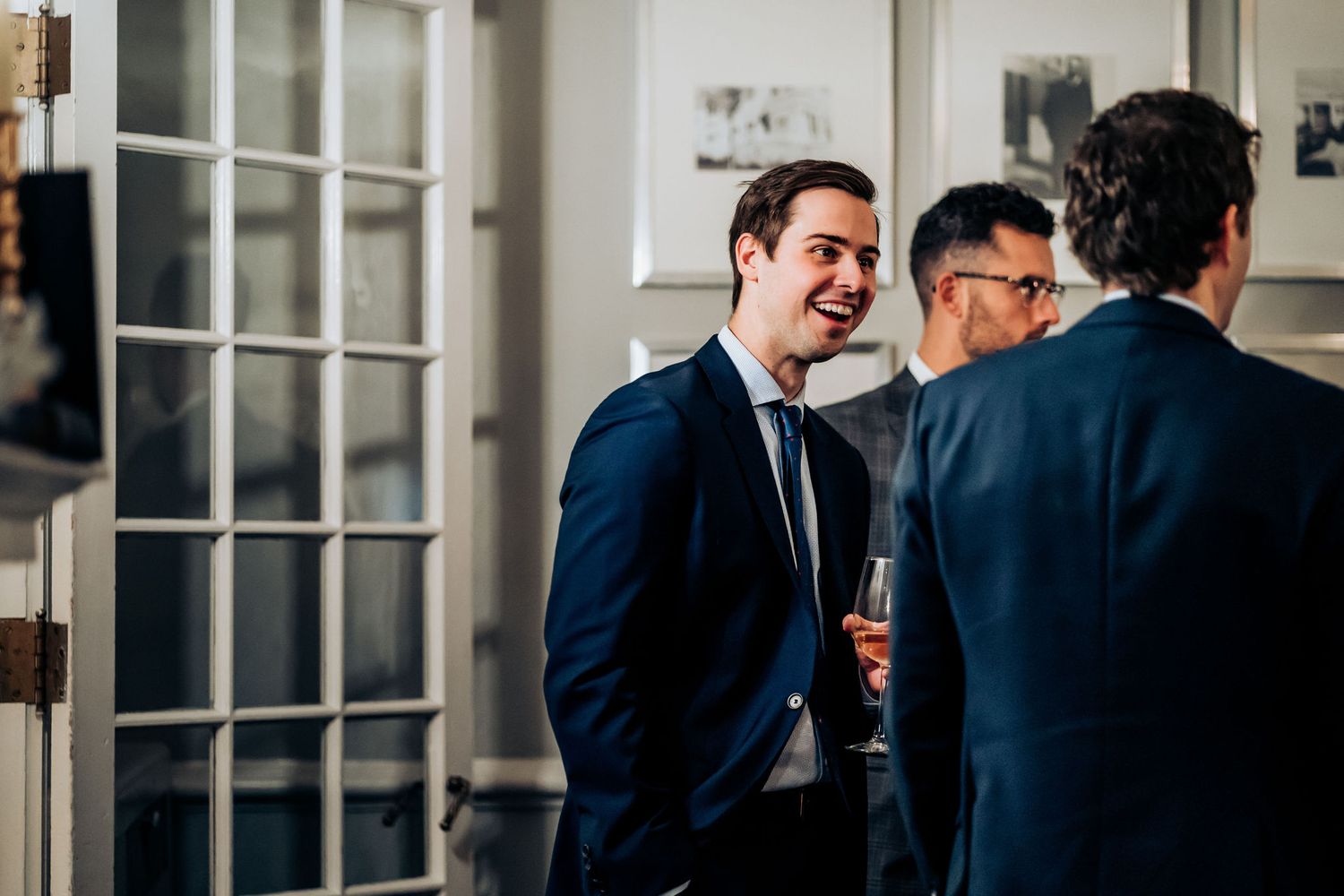 Guests enjoying cocktails and conversation at an elegant wedding reception.