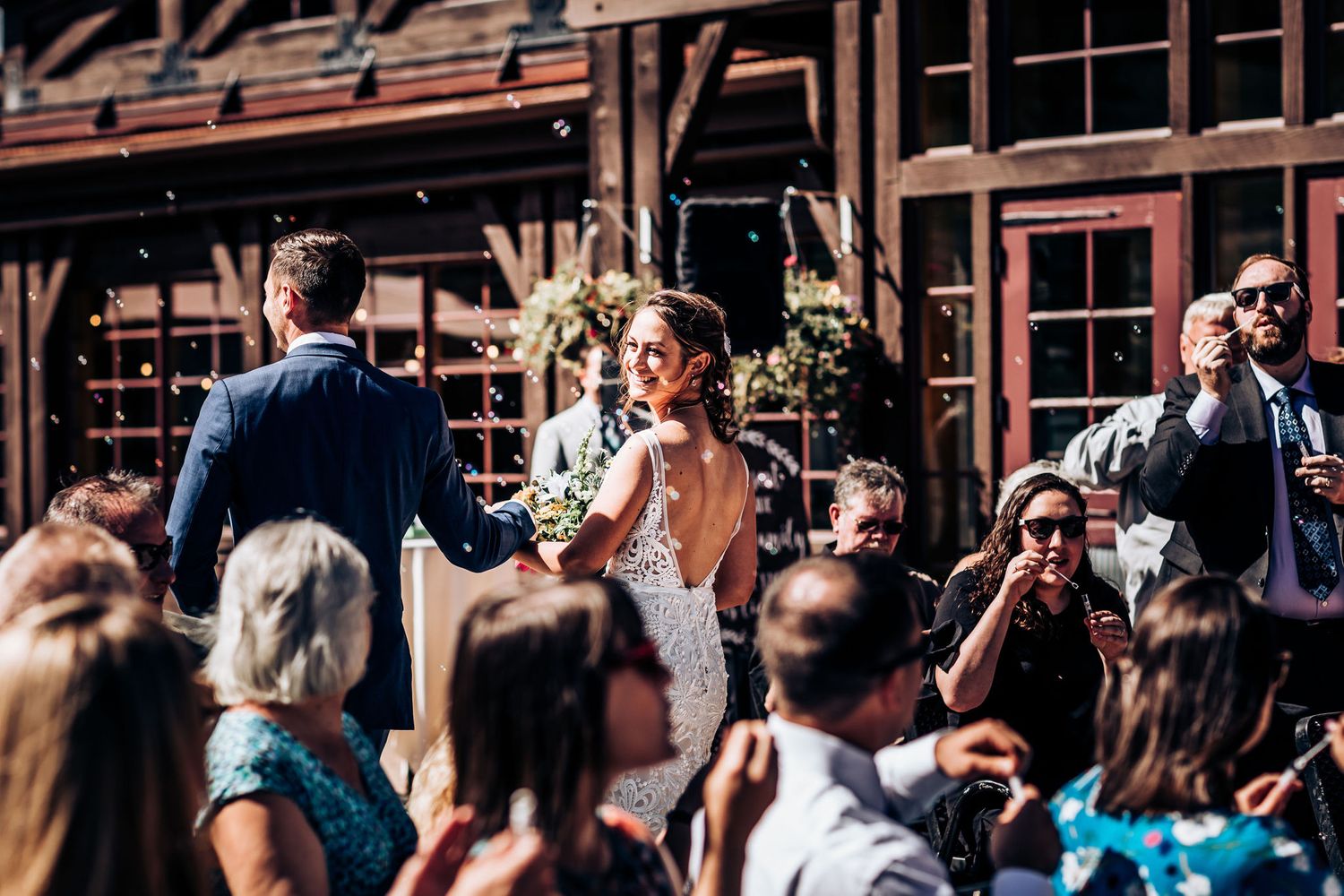 Celebration at rustic mountain lodge during daytime wedding ceremony.