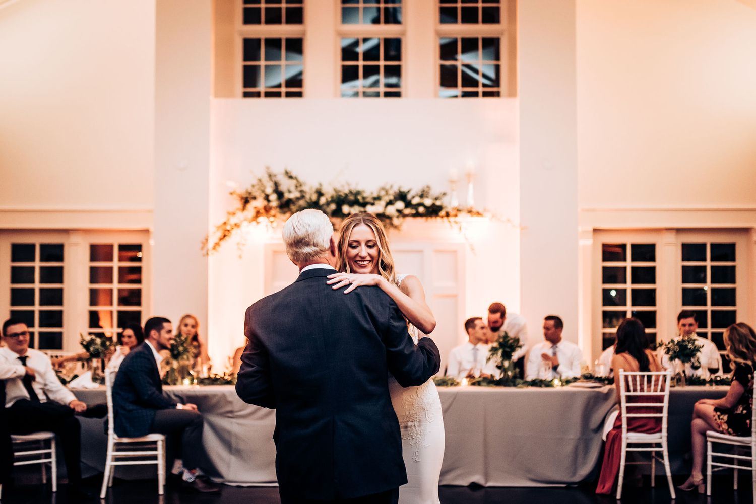 Dancing couple shares a joyful moment on the reception dance floor.