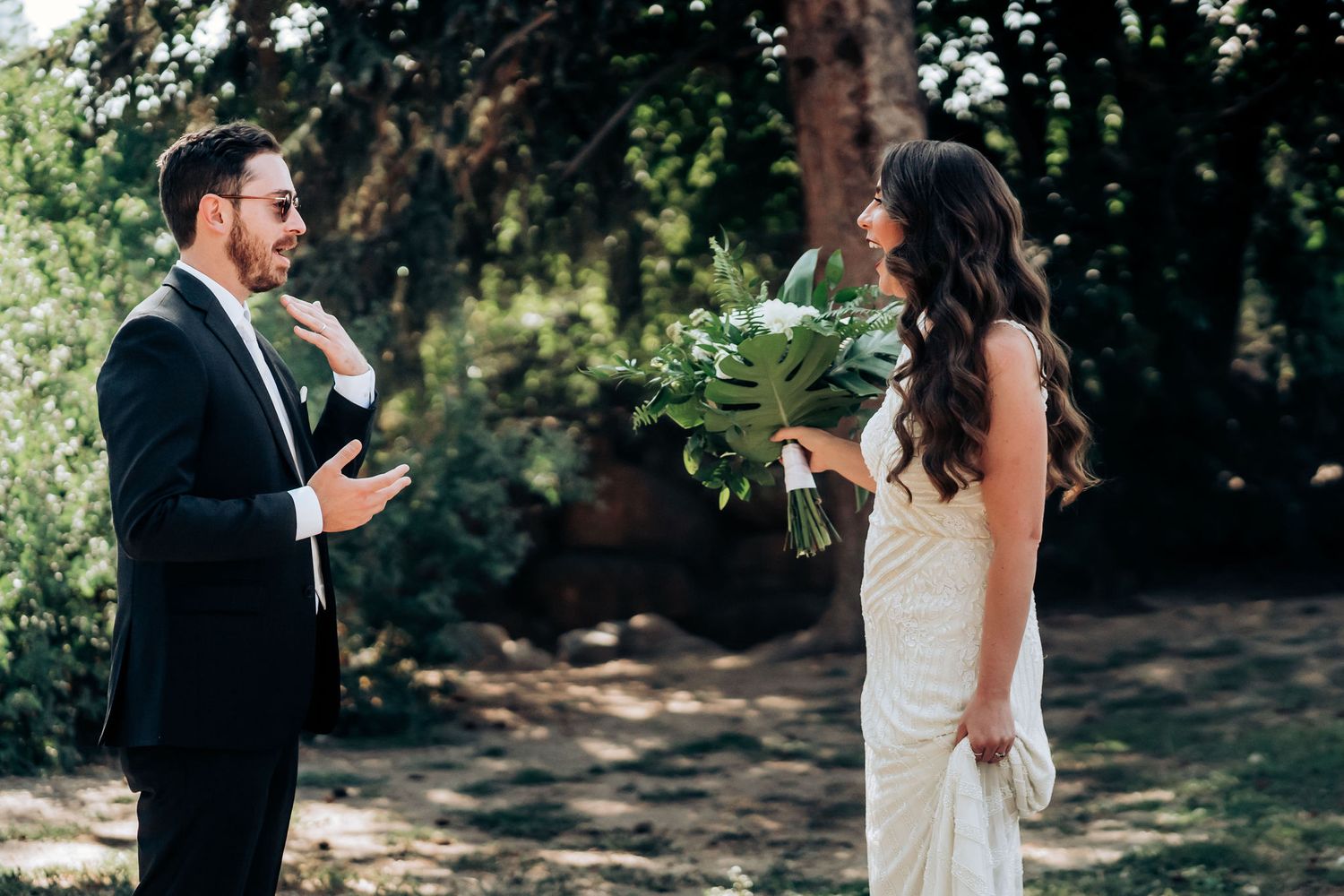 A couple shares an emotional moment during their outdoor wedding ceremony.