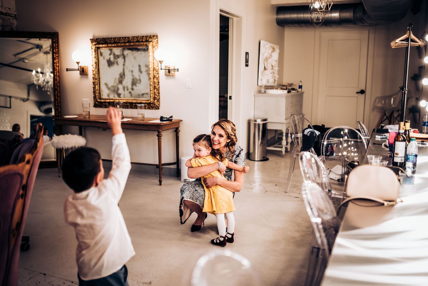 People dance and celebrate in joyful moment at indoor venue with vintage decor.