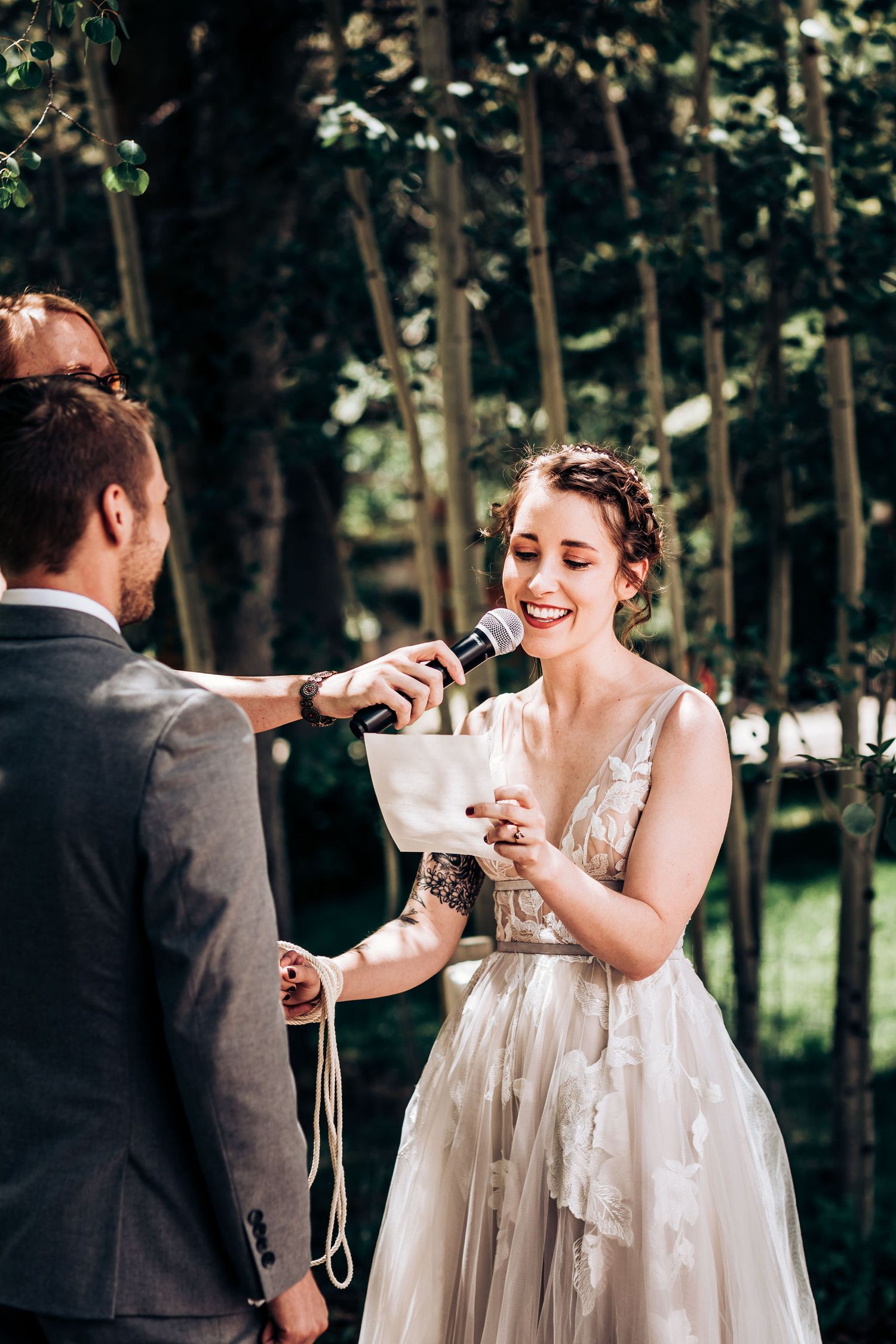 Wedding ceremony in a forest setting with couple sharing a special moment.