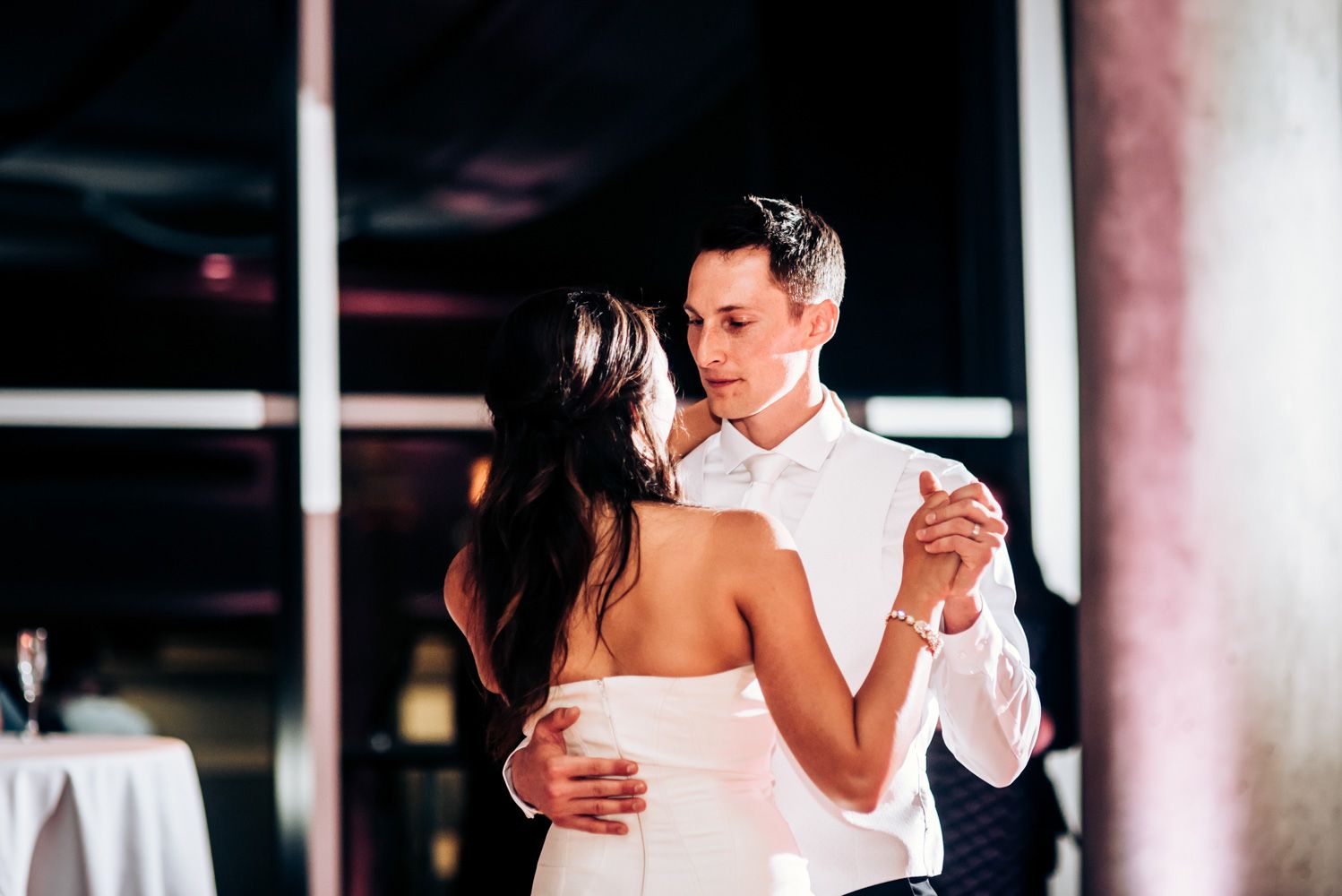A couple shares their first dance moment at an elegant wedding reception.