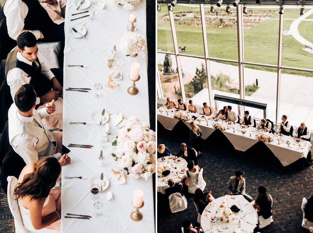 Overhead view of an elegant wedding reception table setup with guests dining and panoramic windows.