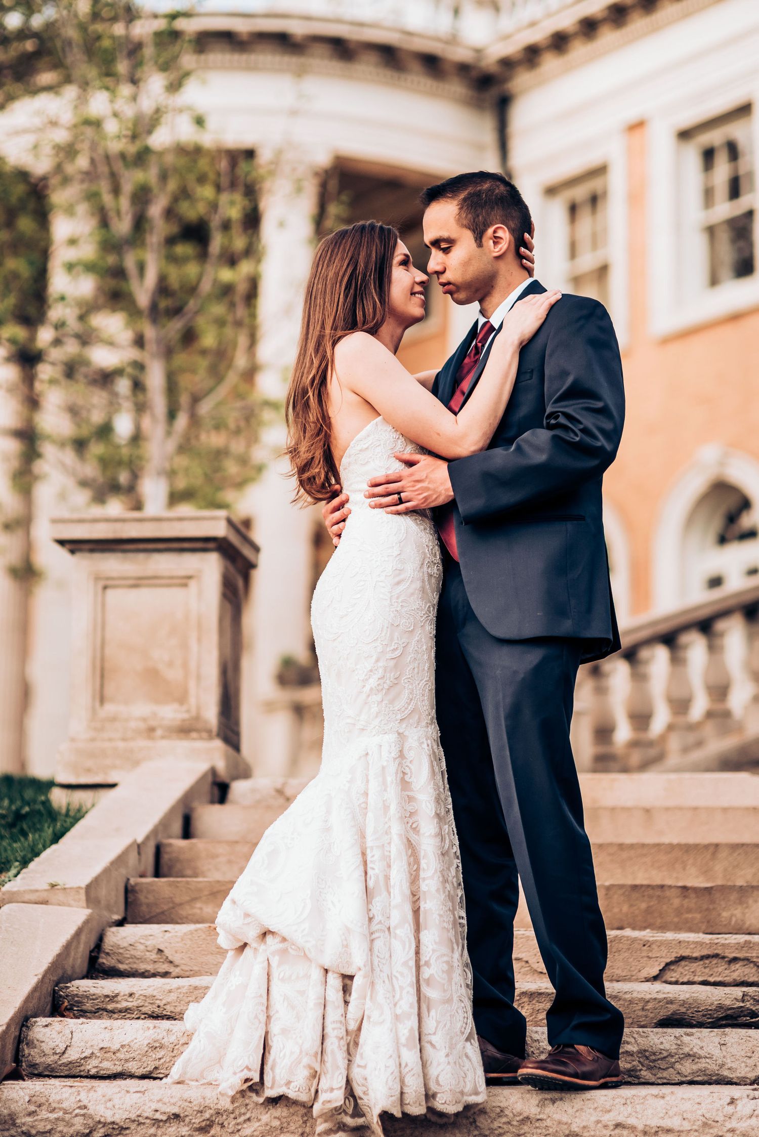 Intimate wedding portrait on grand stone steps with classical architecture.