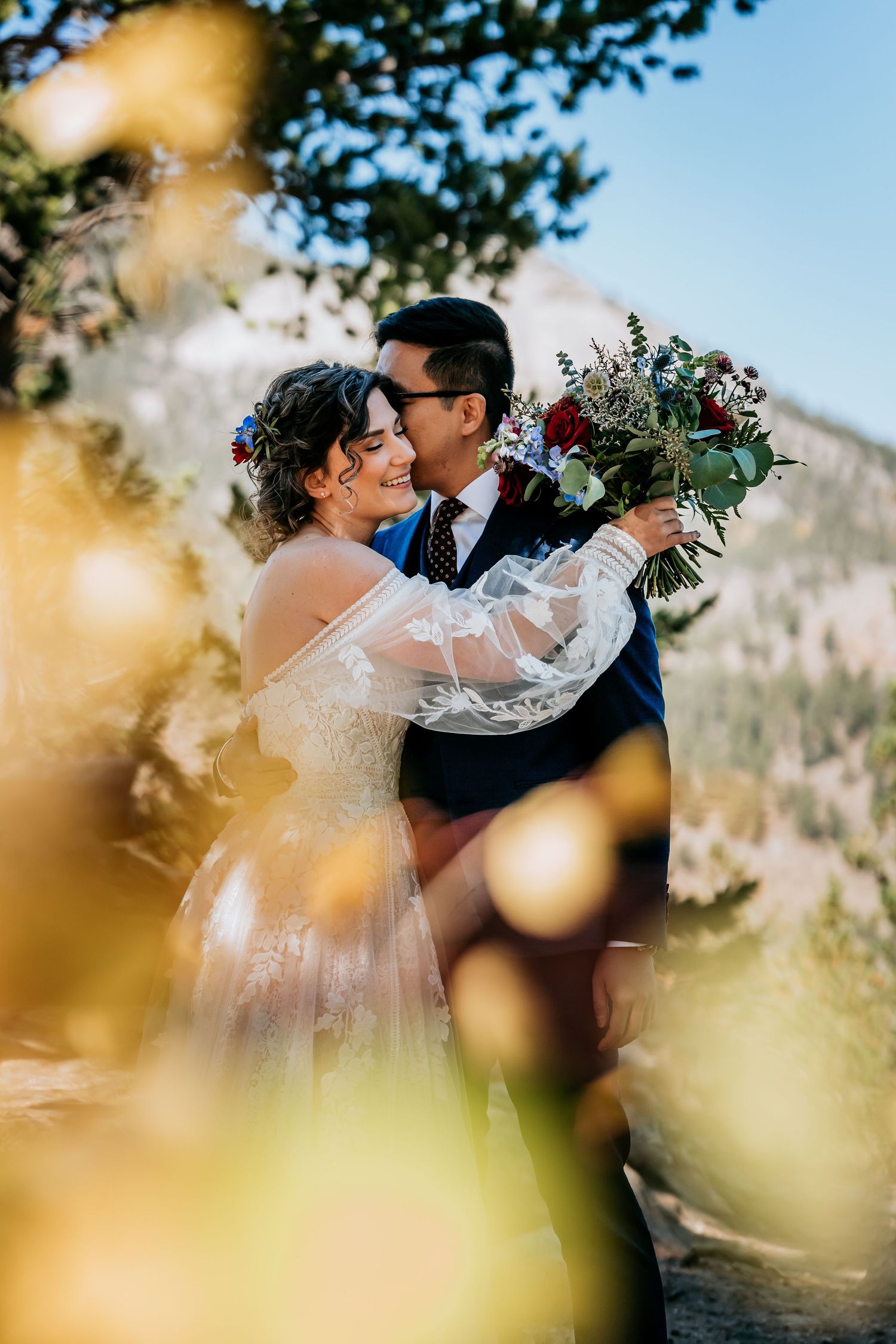 Romantic mountain wedding portraits with golden bokeh effects.