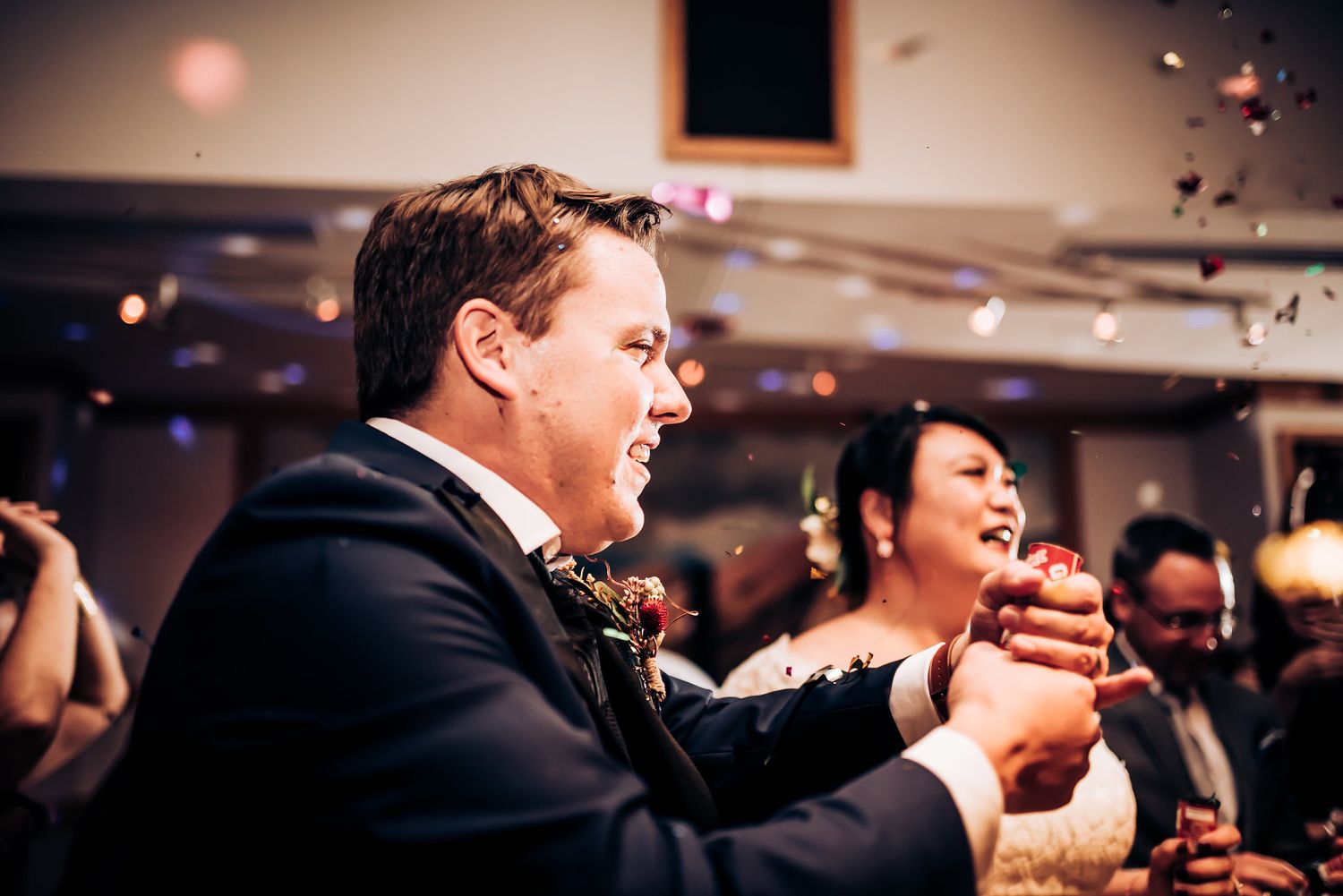 Candid reactions and laughter during a festive wedding reception party.