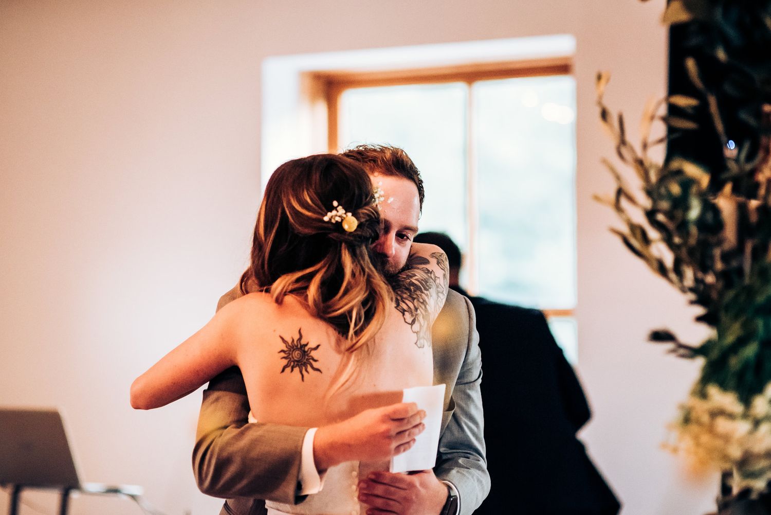 Emotional moment shared between two people embracing during a wedding celebration.