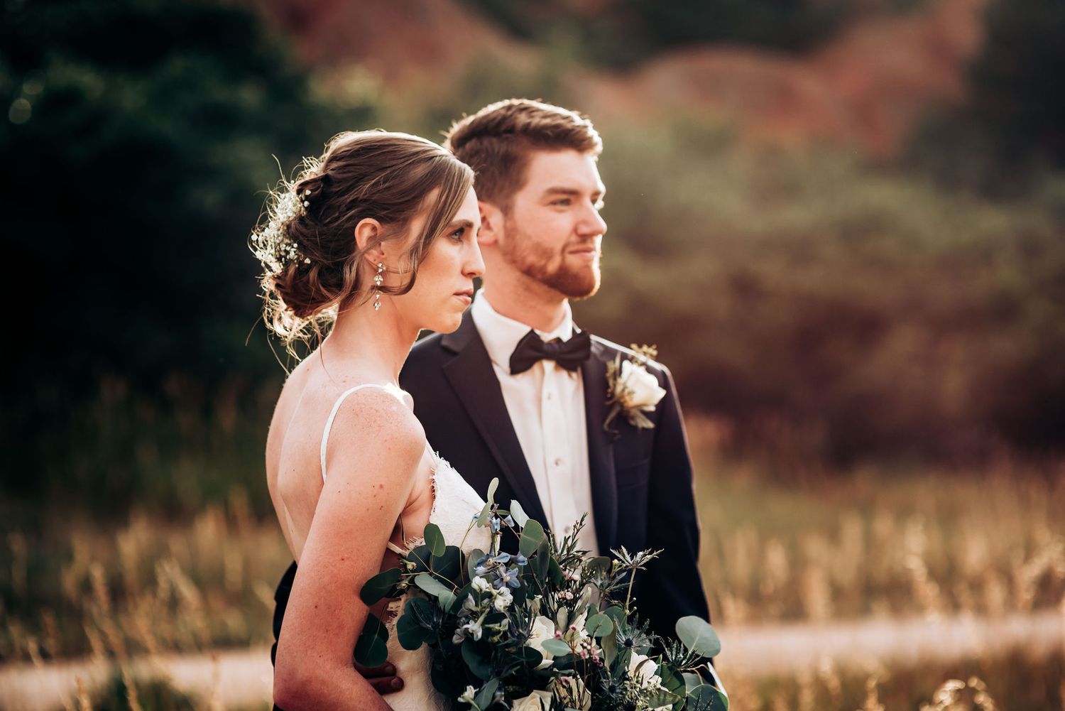 Side profile wedding portrait with red rocks and natural landscape.