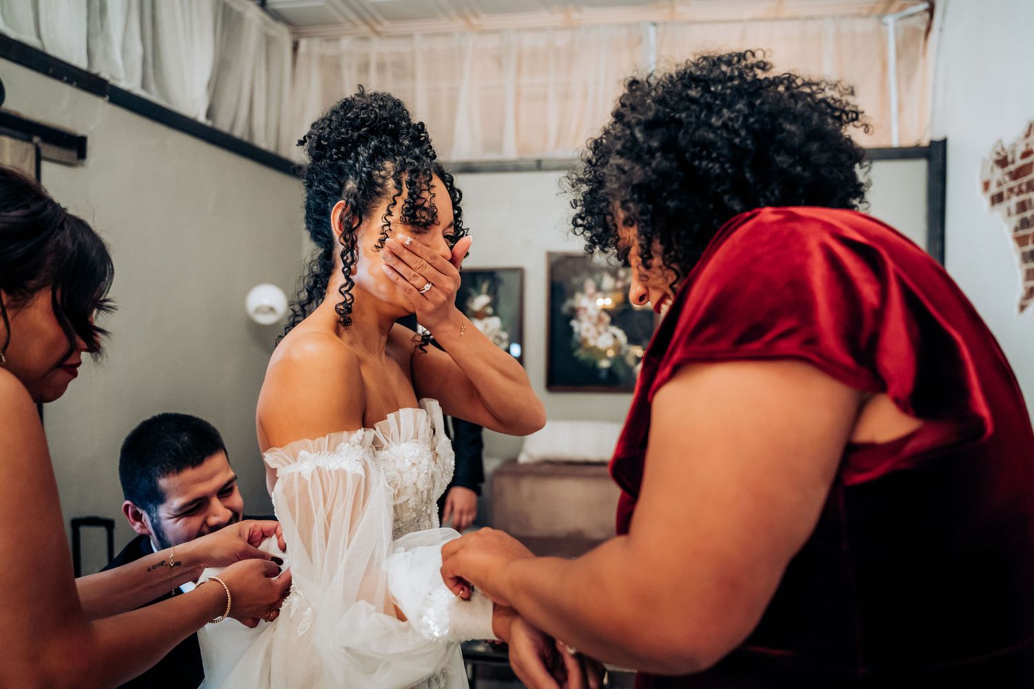 Woman in wedding dress getting fitted and adjusted before the ceremony.