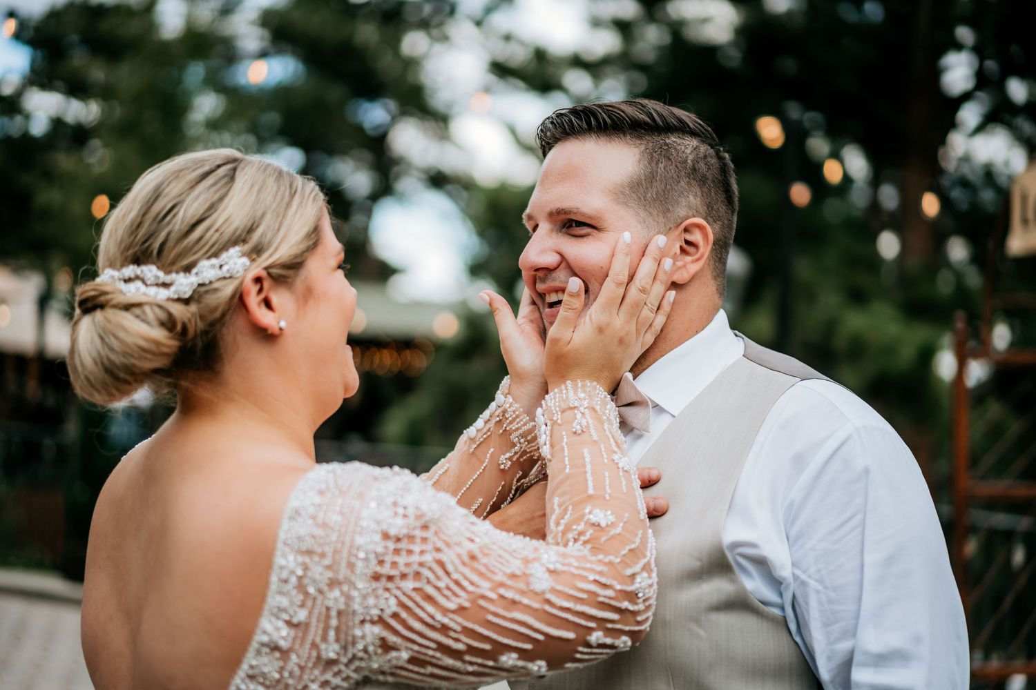 Emotional moment shared between wedding couple during outdoor reception.