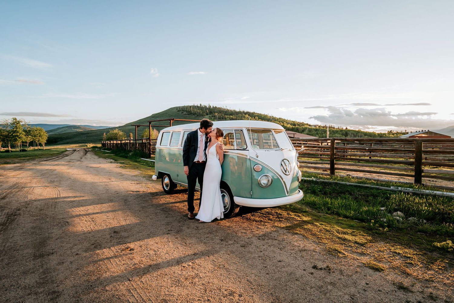 A wedding photoshoot featuring a mint green VW bus against a scenic mountain landscape.
