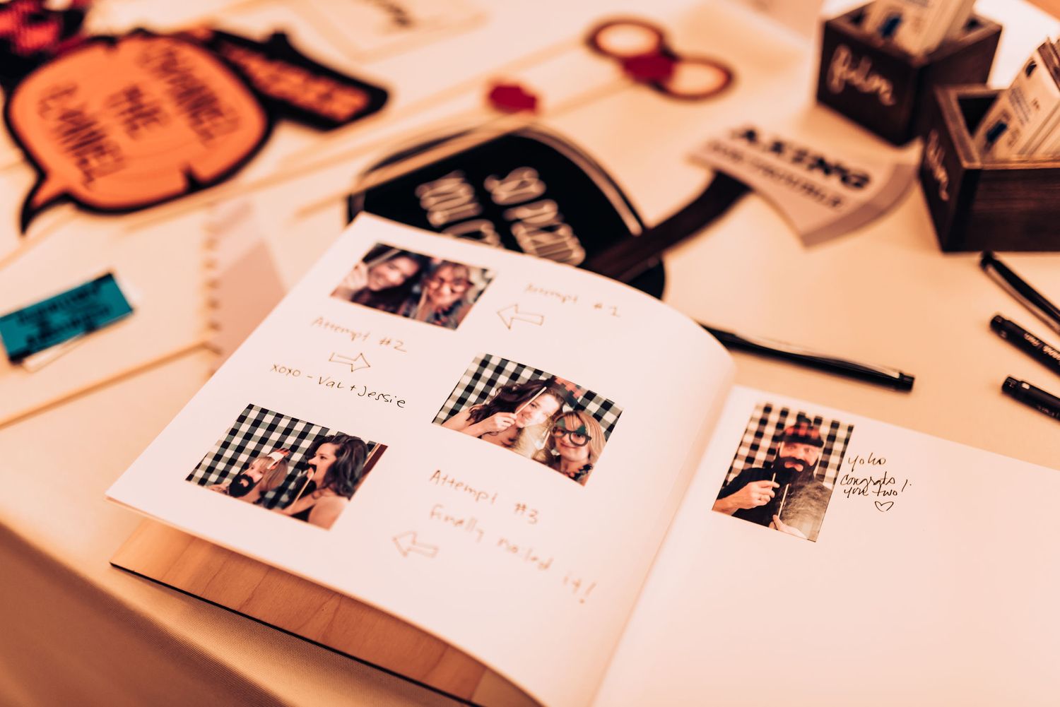 An open guestbook displaying wedding photos and handwritten messages.