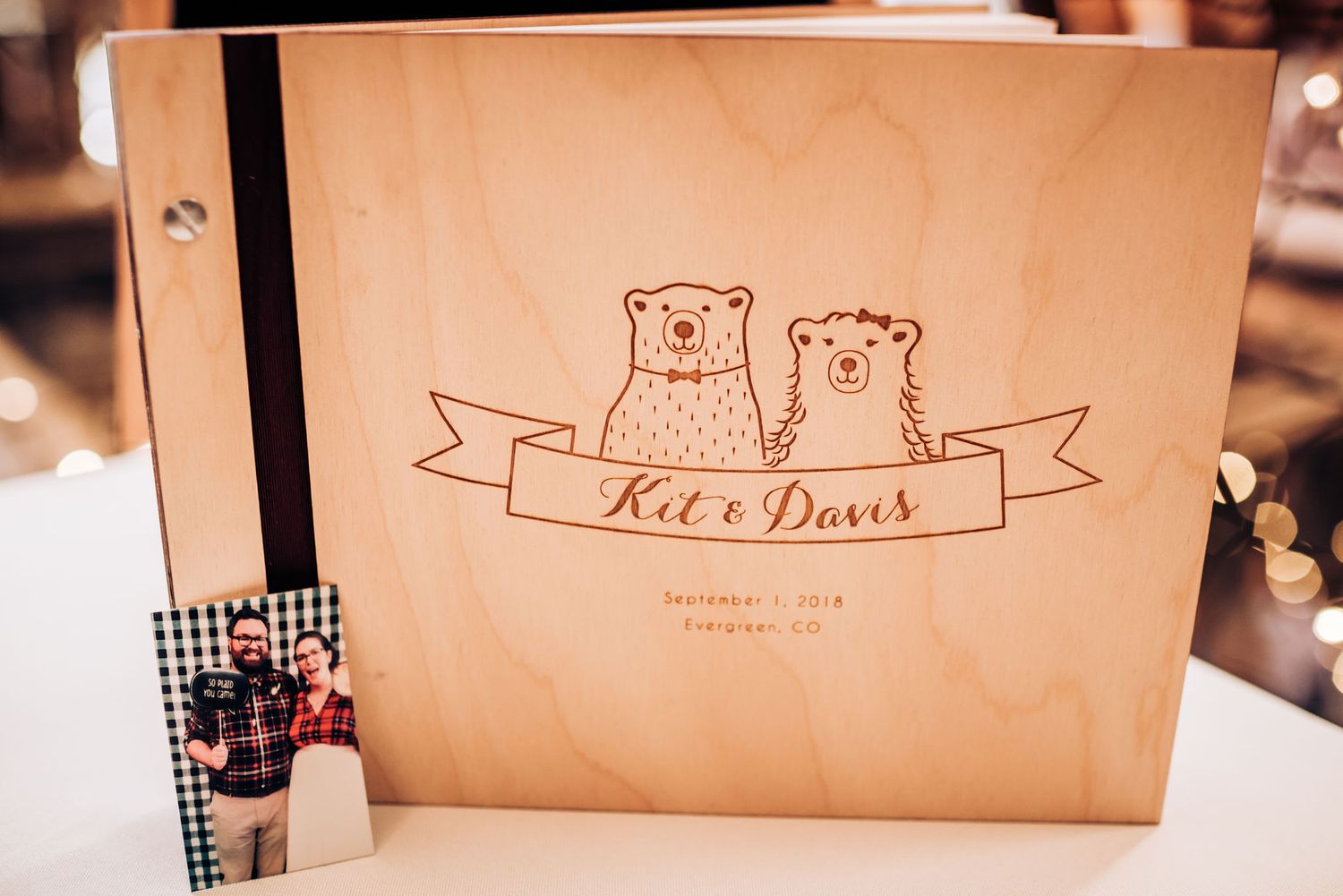 Wedding guestbook with cute bear illustrations on wooden rustic surface.