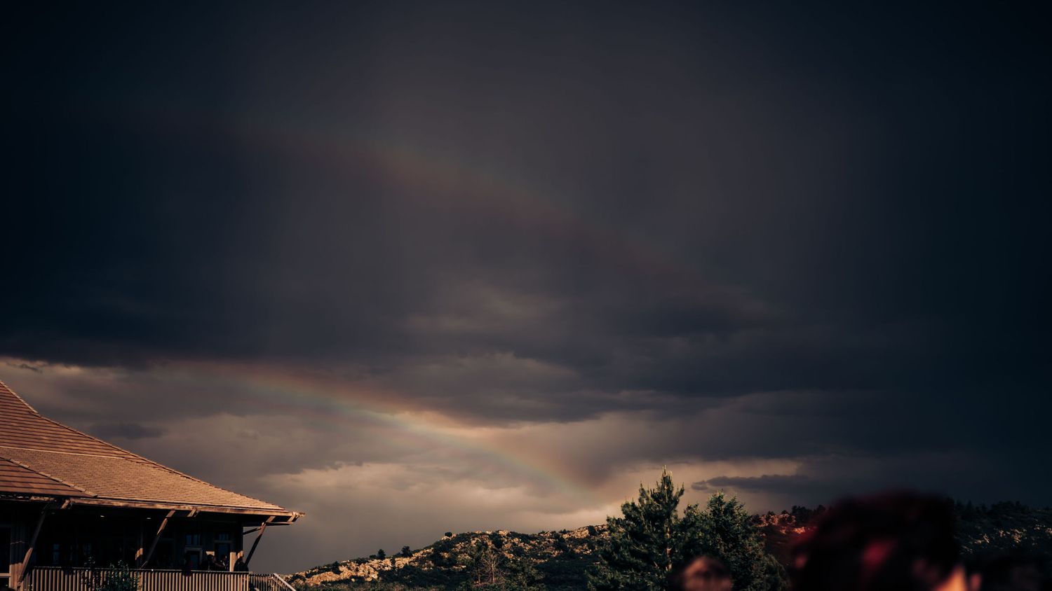 Dramatic stormy sunset sky over mountain landscape at outdoor venue.