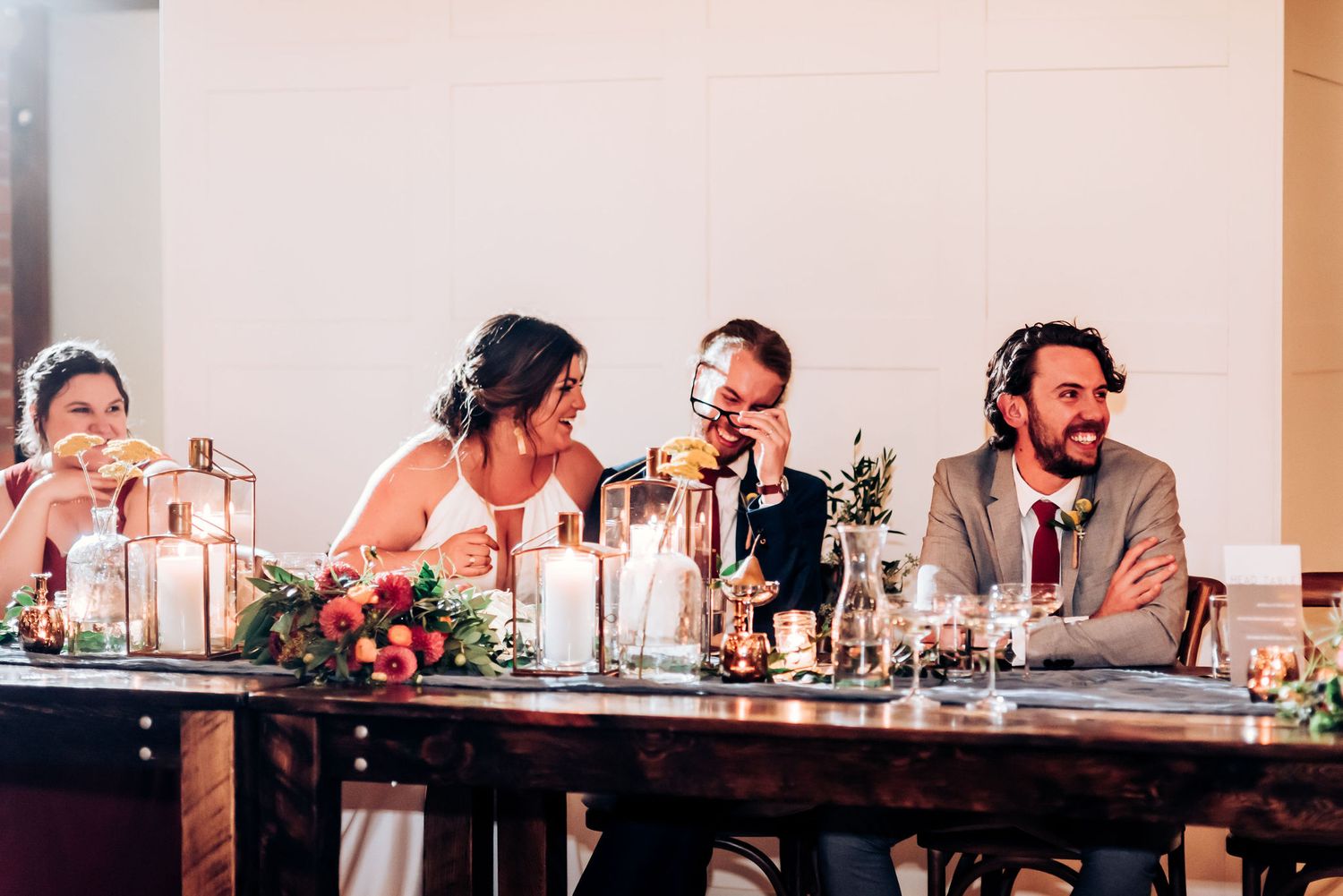 Wedding party seated at head table during reception dinner.
