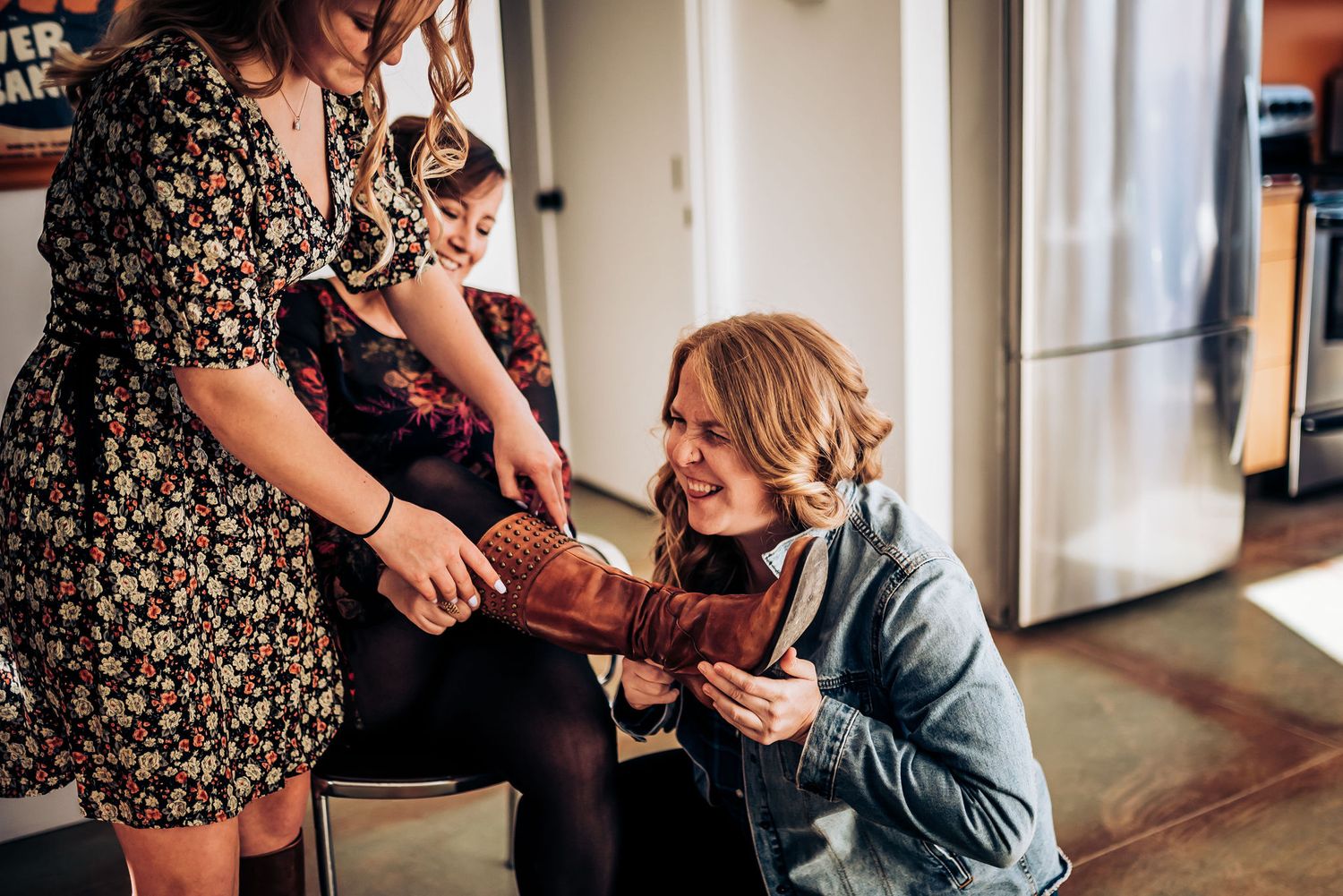 Two people examining vintage camera during casual indoor gathering.