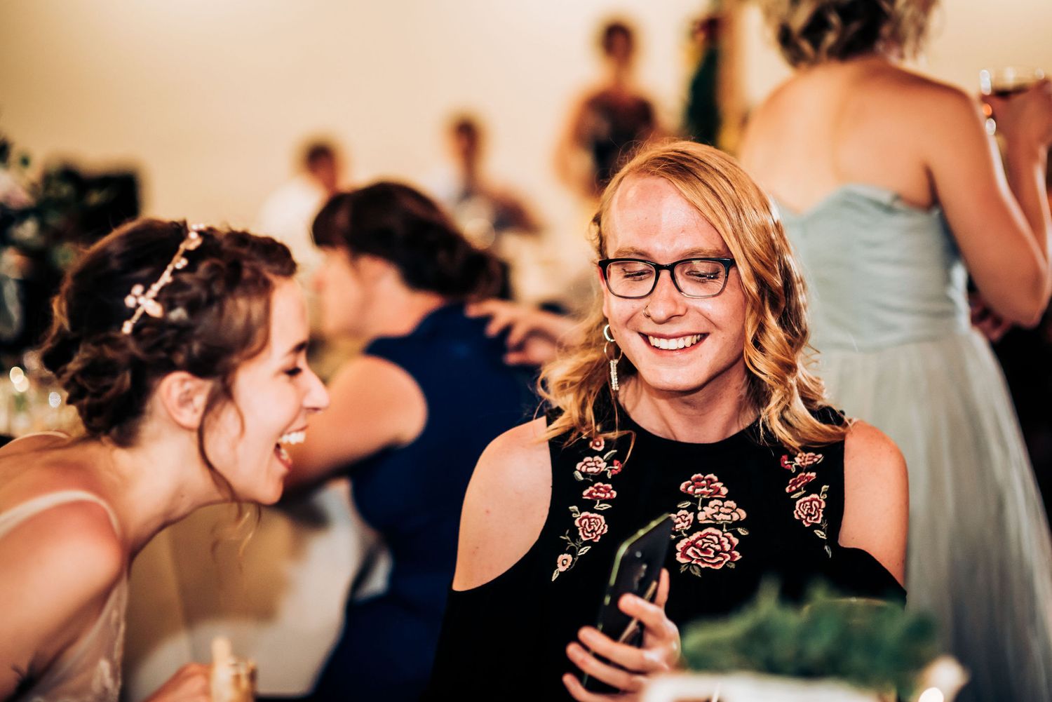 Wedding guests share joyful conversation during reception celebration.