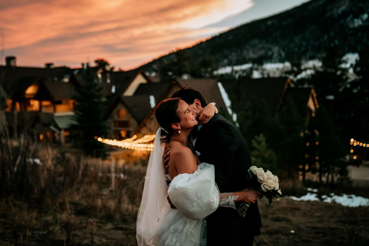 Sunset wedding photography session with mountains and dramatic sky.