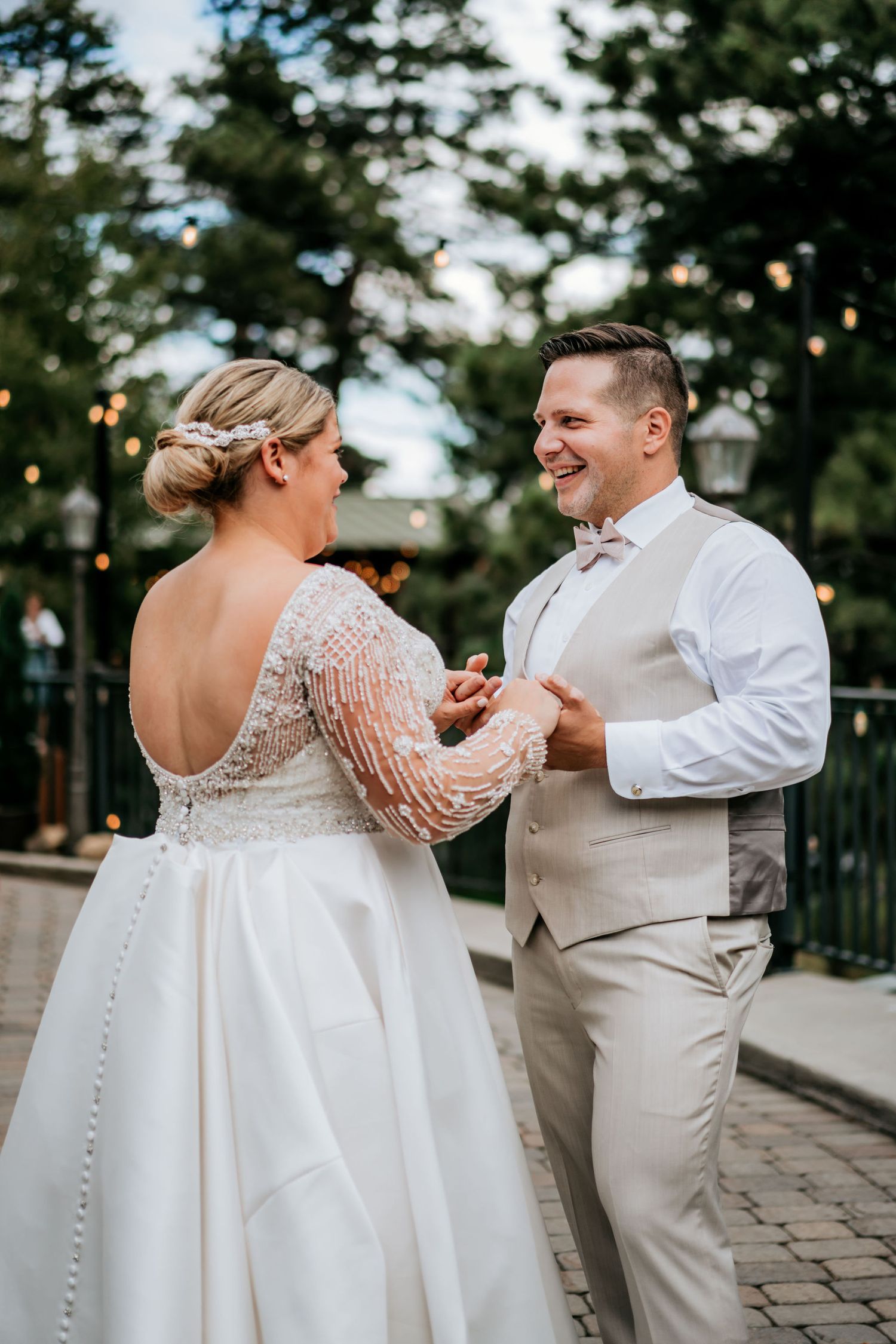 A couple dancing together at an outdoor wedding reception.