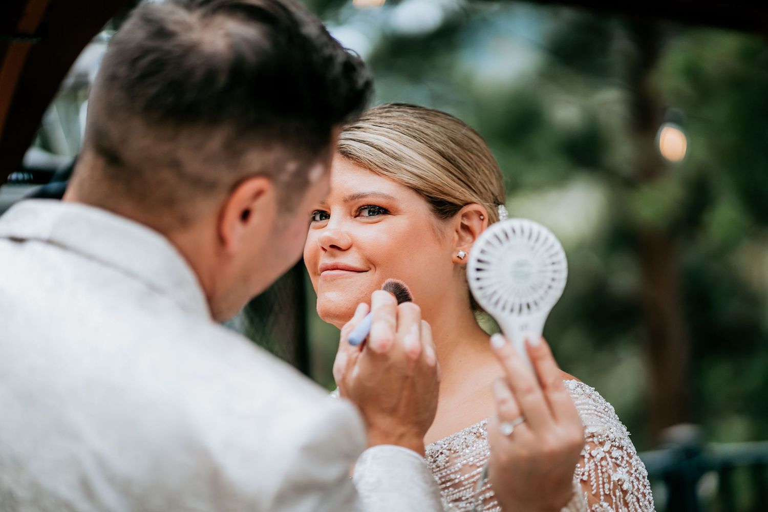 A close-up shot of wedding day makeup application in natural lighting.