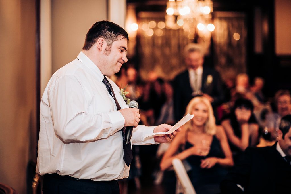 Speaker delivers an emotional wedding speech during reception festivities.