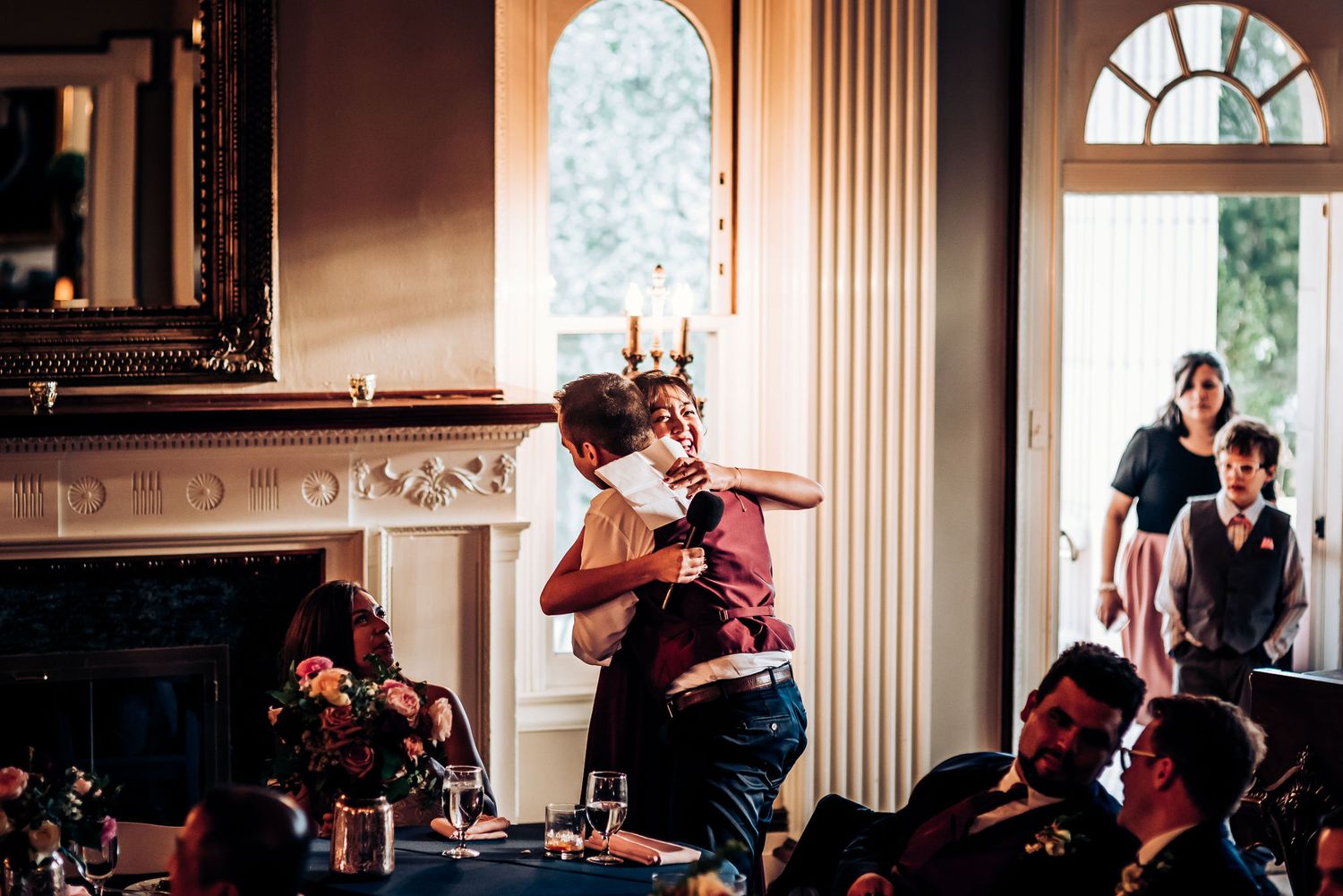 Energetic celebration with dancing and entertainment at an indoor wedding reception.