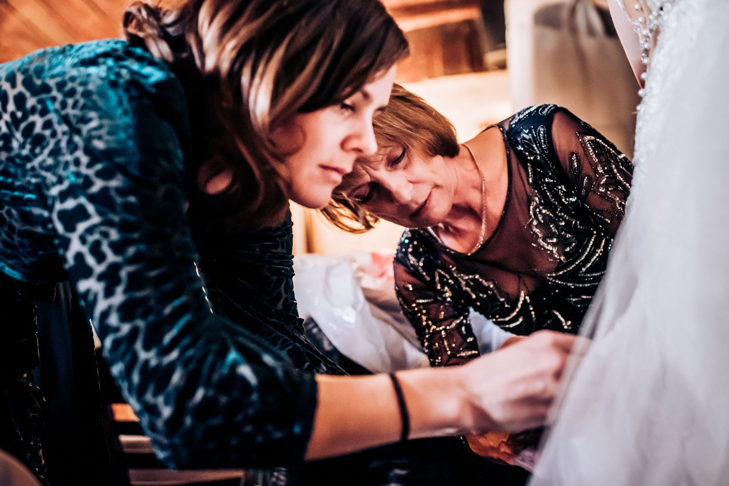 Close-up of wedding dress alterations being made during final fitting.