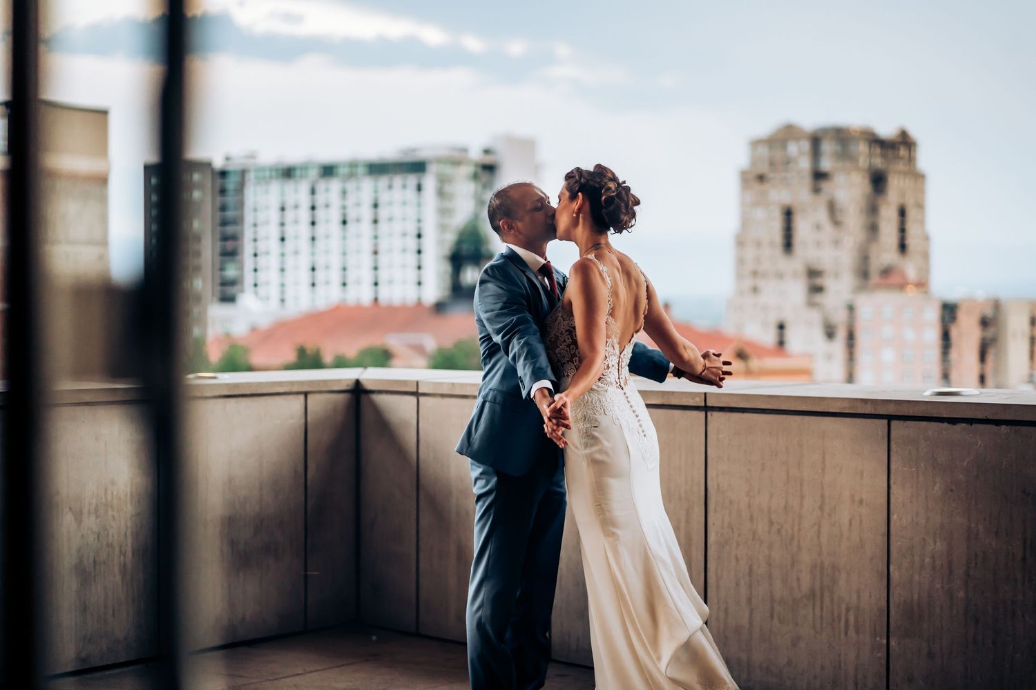 Couple sharing a romantic moment on an urban rooftop.