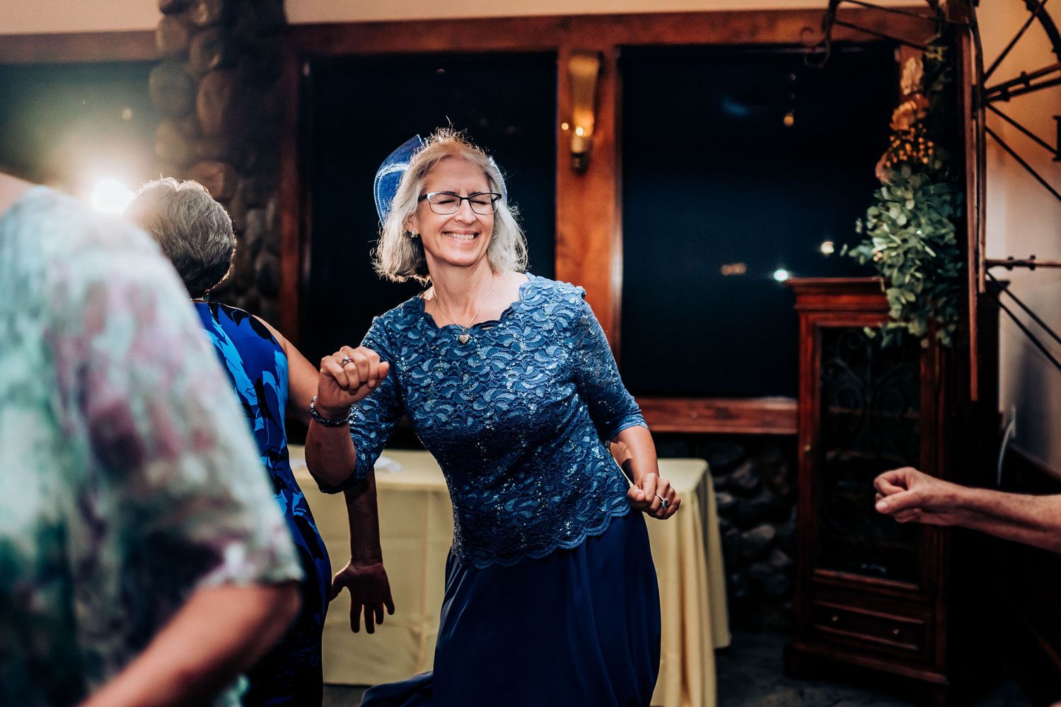 Guests enjoying themselves while dancing at an evening wedding reception.